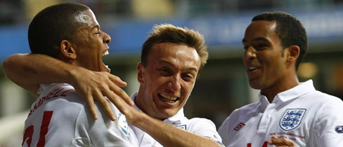 Mark Noble and Theo Walcott congratulate Fraizer Campbell after his goal put England 1-0 up.